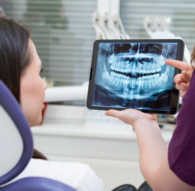 Dentist reviewing a digital dental X-ray image