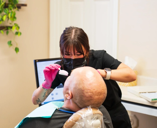 Patient receiving routine dental care from a dentist