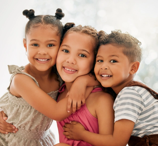 Children smiling together during a dental visit