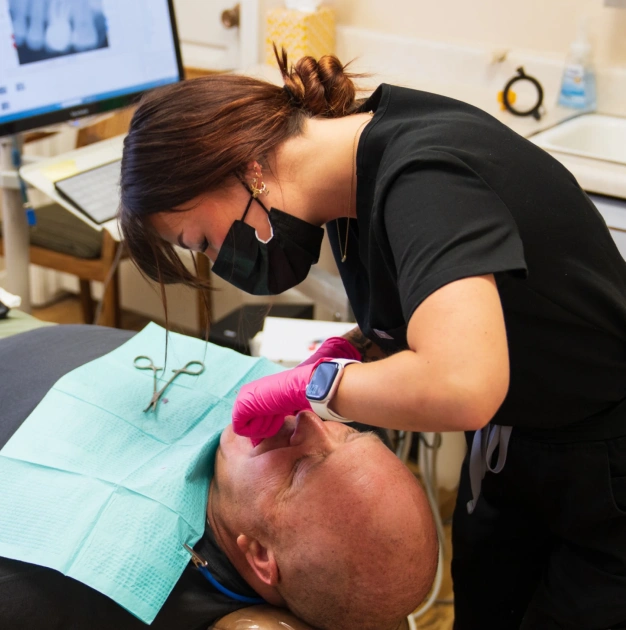 Dentist performing a tooth extraction procedure