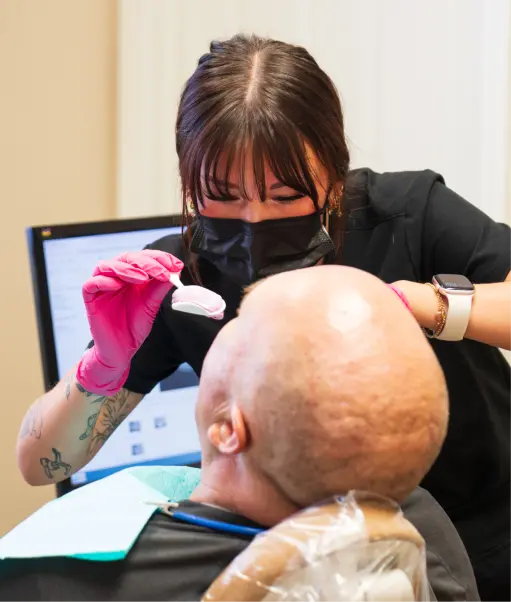 Dental professional treating a patient in the clinic
